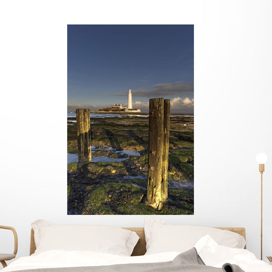 Wooden Posts And Lighthouse In Distance Wall Mural