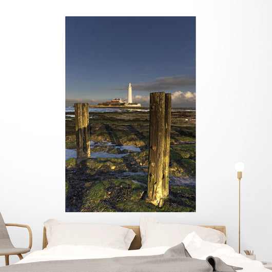 Wooden Posts And Lighthouse In Distance Wall Mural