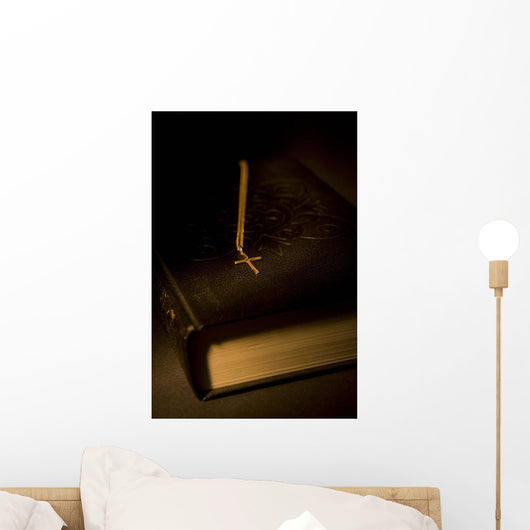 Gold Cross Pendant Resting On A Book Wall Mural