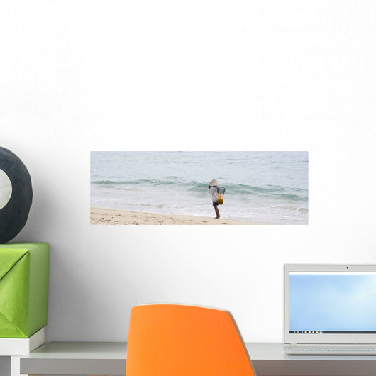Person Walking On The Beach With A Fishing Net Wall Mural