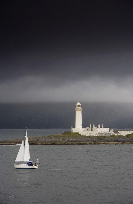 Sailboat Near A Shore With A Lighthouse Wall Mural