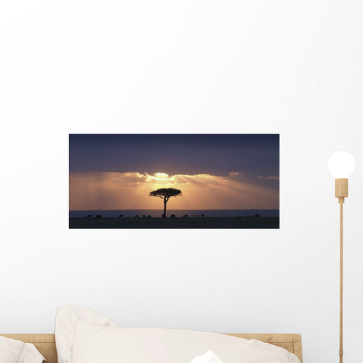 An Acacia Tree And Wildebeest Under A Sunset Wall Mural