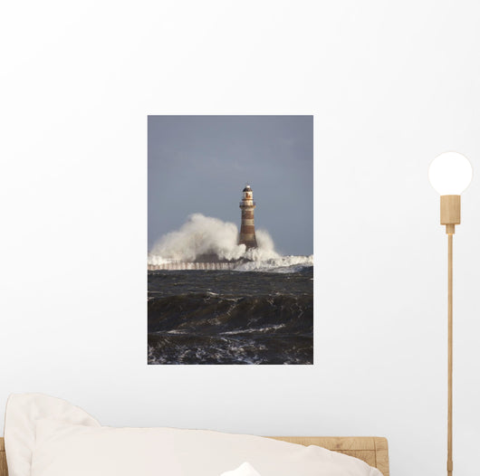 Waves Crashing Against A Lighthouse Wall Mural