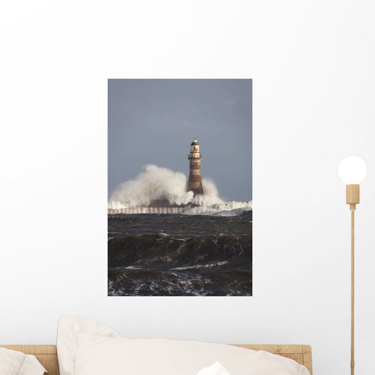 Waves Crashing Against A Lighthouse Wall Mural