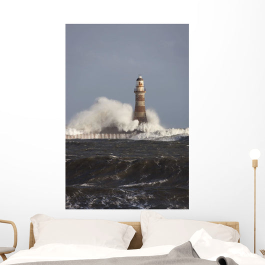 Waves Crashing Against A Lighthouse Wall Mural