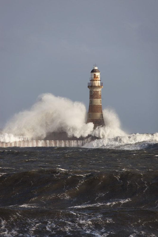 Waves Crashing Against A Lighthouse Wall Mural