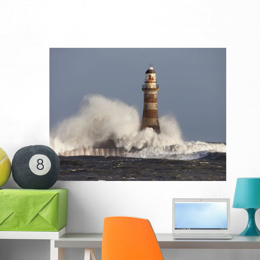 Waves Crashing Against A Lighthouse Wall Mural