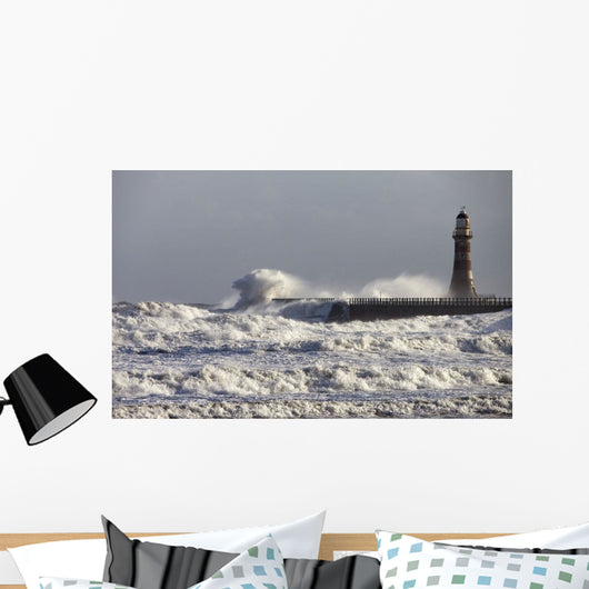 Waves Crashing Against A Pier With A Lighthouse Wall Mural