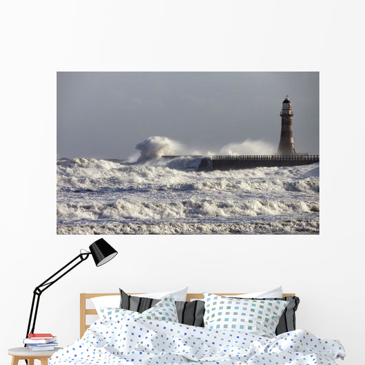 Waves Crashing Against A Pier With A Lighthouse Wall Mural