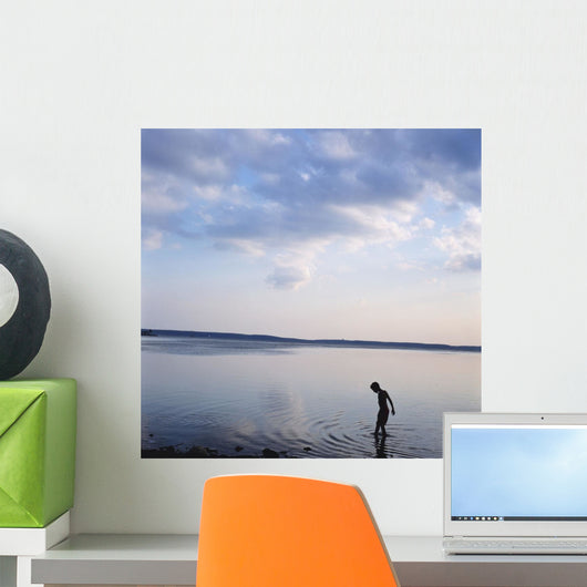 Boy In Silhouette Wading In Ocean Wall Mural