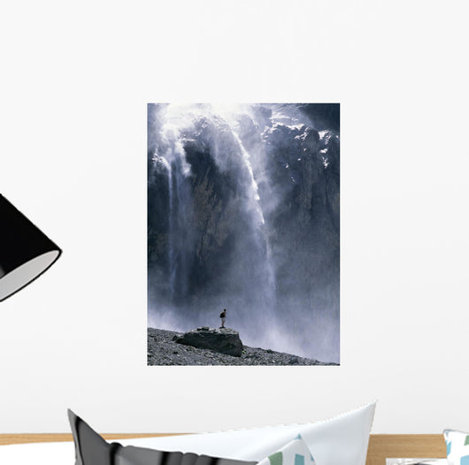 Walker Beneath Waterfall In The Cirque De Gavarnie Wall Mural