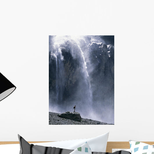 Walker Beneath Waterfall In The Cirque De Gavarnie Wall Mural