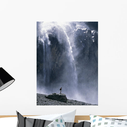 Walker Beneath Waterfall In The Cirque De Gavarnie Wall Mural