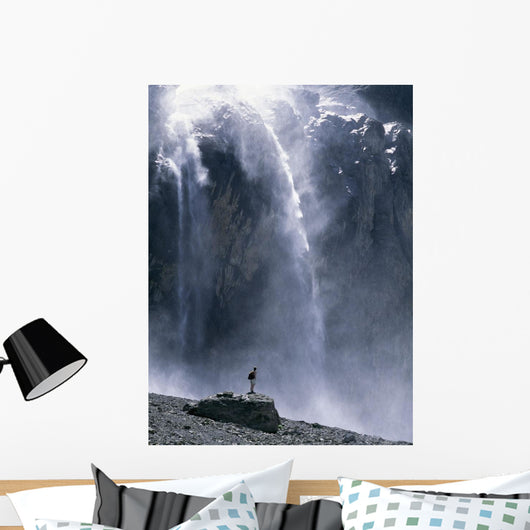 Walker Beneath Waterfall In The Cirque De Gavarnie Wall Mural