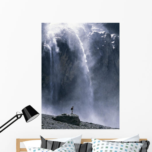 Walker Beneath Waterfall In The Cirque De Gavarnie Wall Mural