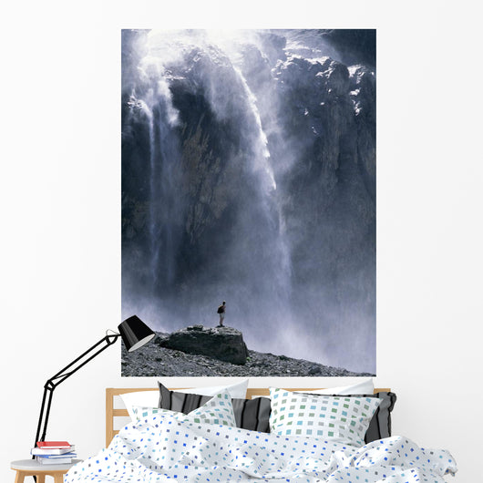 Walker Beneath Waterfall In The Cirque De Gavarnie Wall Mural