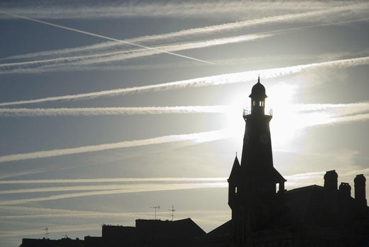 Airplane Contrails Above Lighthouse Wall Mural