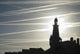 Airplane Contrails Above Lighthouse Wall Mural
