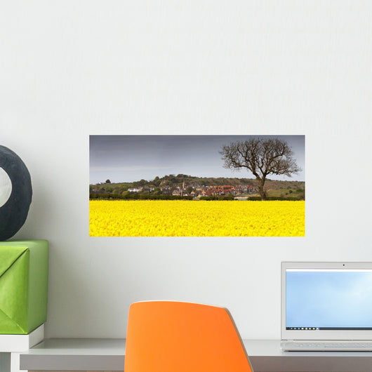 A Field Of Yellow Flowers Beside A Village Wall Mural