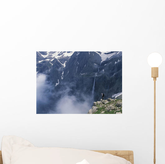 Walker Looking Over Waterfall At Cirque De Gavarnie Wall Mural