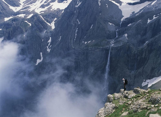 Walker Looking Over Waterfall At Cirque De Gavarnie Wall Mural