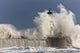 Waves Crashing Up Against A Lighthouse Wall Mural