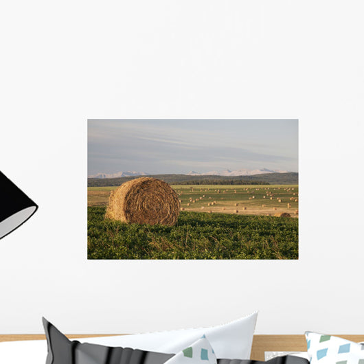 Hay Bales In A Field With Mountains In The Background At Sunrise Wall Mural