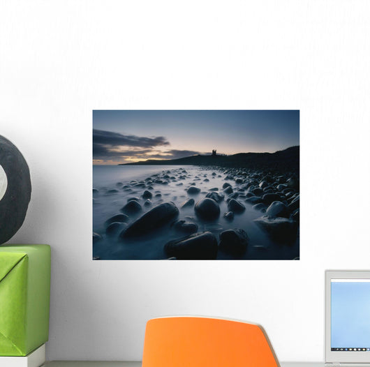 Large Boulders On Beach Near Dunstanburgh Castle At Dawn Wall Mural