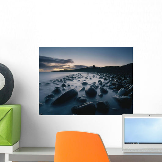 Large Boulders On Beach Near Dunstanburgh Castle At Dawn Wall Mural