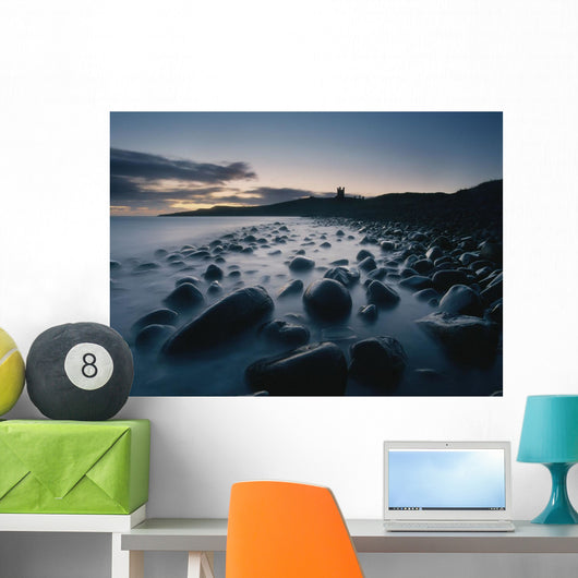 Large Boulders On Beach Near Dunstanburgh Castle At Dawn Wall Mural