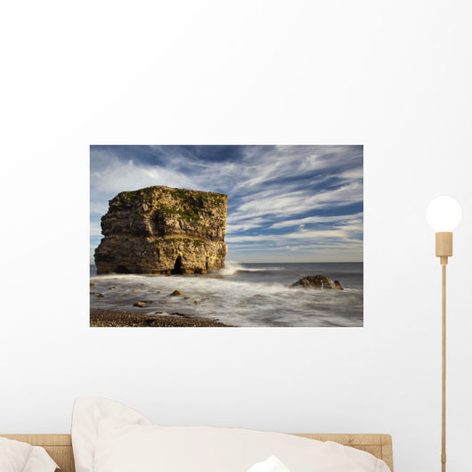A Large Rock Formation Off The Coast Wall Mural