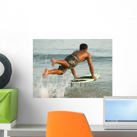 A Man Entering The Water On A Surf Board Off Valdevaqueros Beach Wall Mural