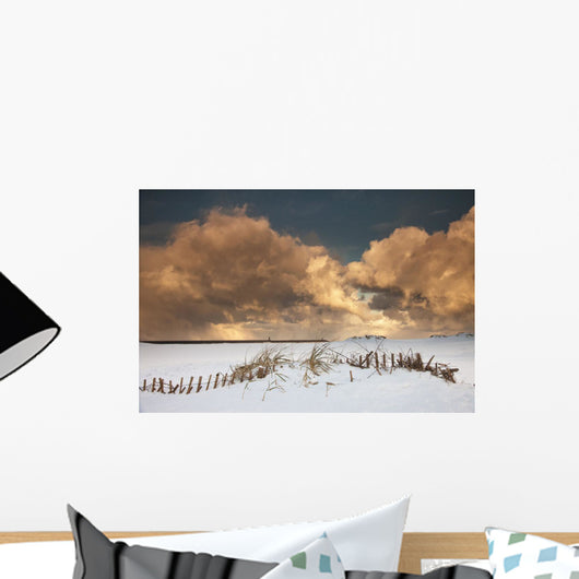 Illuminated Clouds Glowing Above A Snowy Field Wall Mural