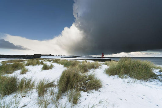 Dark Clouds And Blue Sky Over A Red Lighthouse Along The Coast Wall Mural