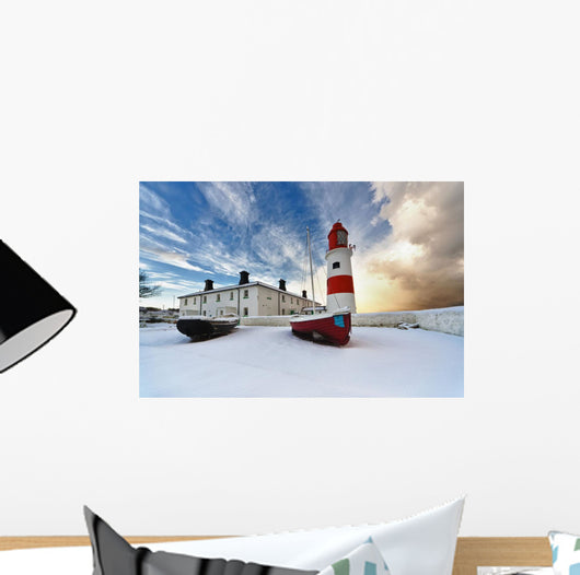 Boats Sitting On A Frozen Surface With A Lighthouse And Building Wall Mural