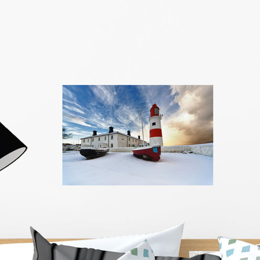 Boats Sitting On A Frozen Surface With A Lighthouse And Building Wall Mural