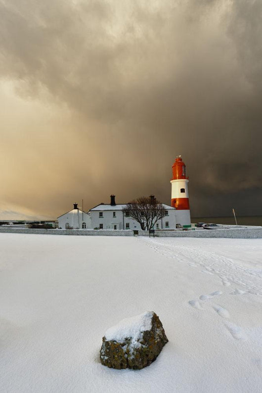A Lighthouse And Building In Winter Wall Mural
