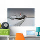 A Snow Covered Fence With A Lighthouse And Building In The Background Wall Mural