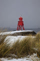 A Red Lighthouse Along The Coast Wall Mural
