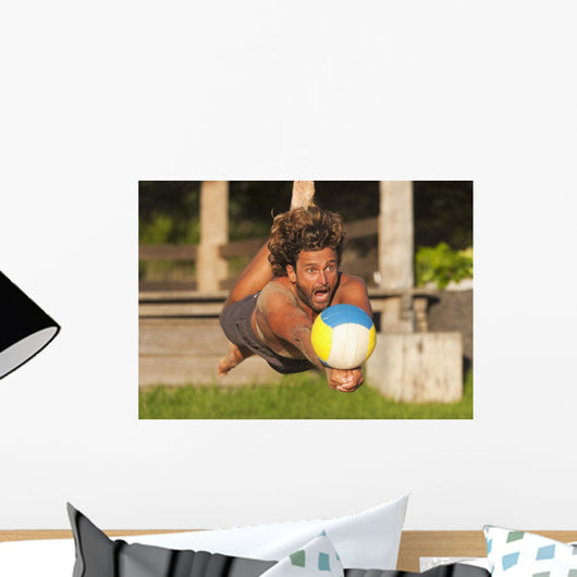 A Man Diving For A Beach Ball Wall Mural