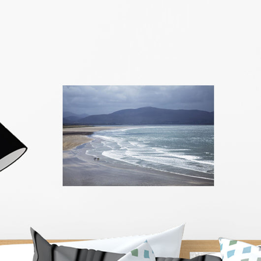 Two People Walking With Surfboards On The Beach Wall Mural