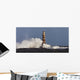 Waves Crashing Against A Lighthouse Wall Mural