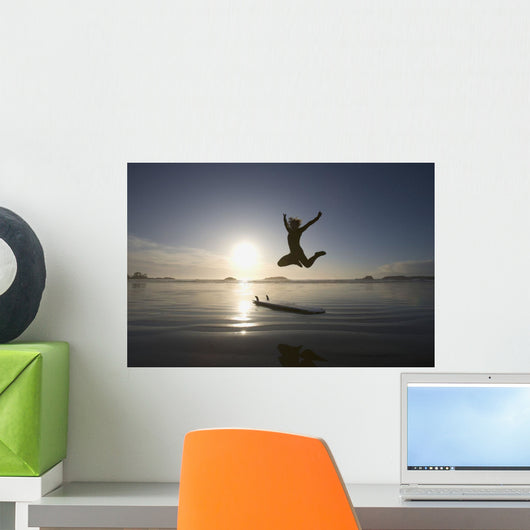 Silhouette Of Female Surfer Jumping For Joy Wall Mural