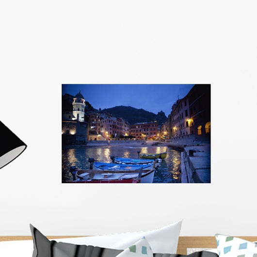 Boats Moored By Buildings Along The Waterfront At Night Wall Mural