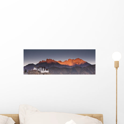 A Building On A Rock Ledge With Alpenglow Over The Mountains Wall Mural