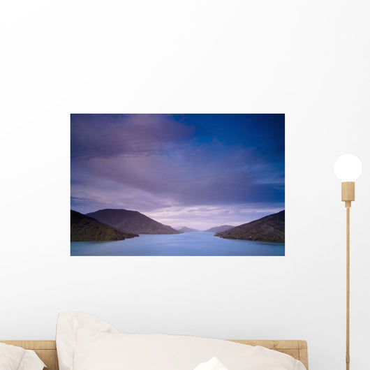 Mountains Along The Coastline Under A Cloudy Sky Wall Mural