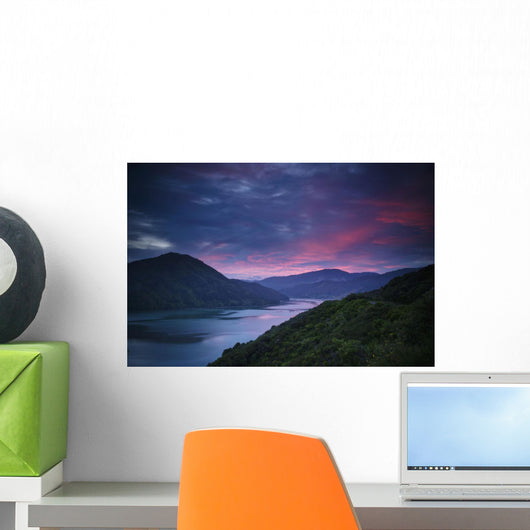 Mountains Along The Coastline Under A Red Sky At Sunset Wall Mural