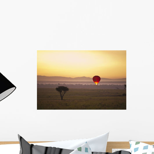 A Red Hot Air Balloon Takes Flight Against The Glowing Sky At Sunset Wall Mural