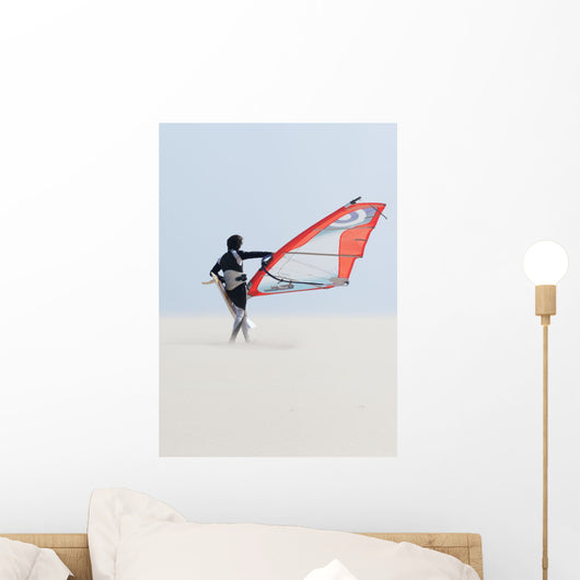 A Windsurfer Walks On The Sand Of Punta Paloma Beach With His Board Wall Mural