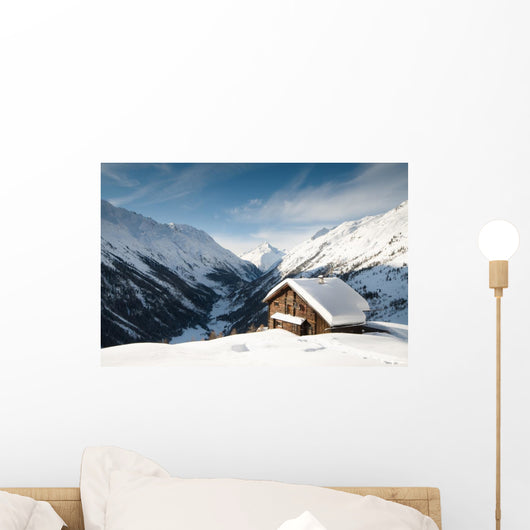 winterscene of alpine valley with snow coverd cabin Wall Mural